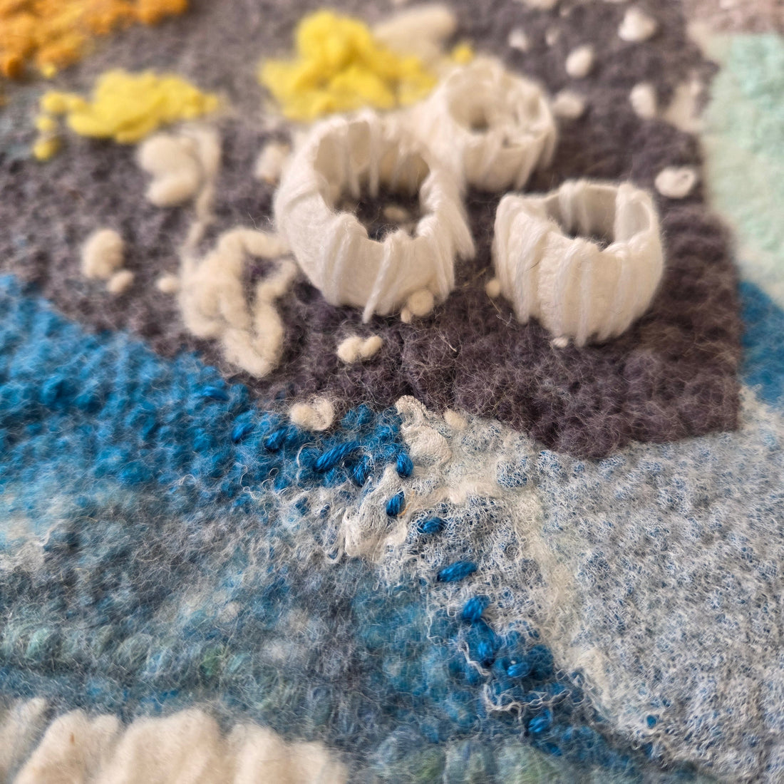 textile piece felted from wool and silk, showing silk cocoons representing barnacles