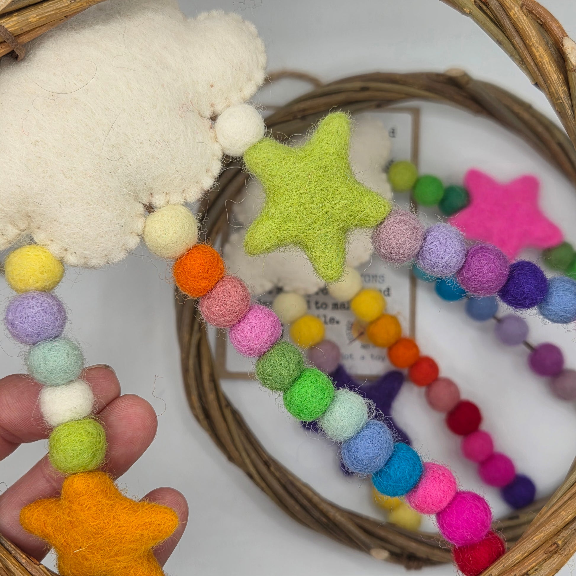 Colorful star and pom-pom decorations on a white background