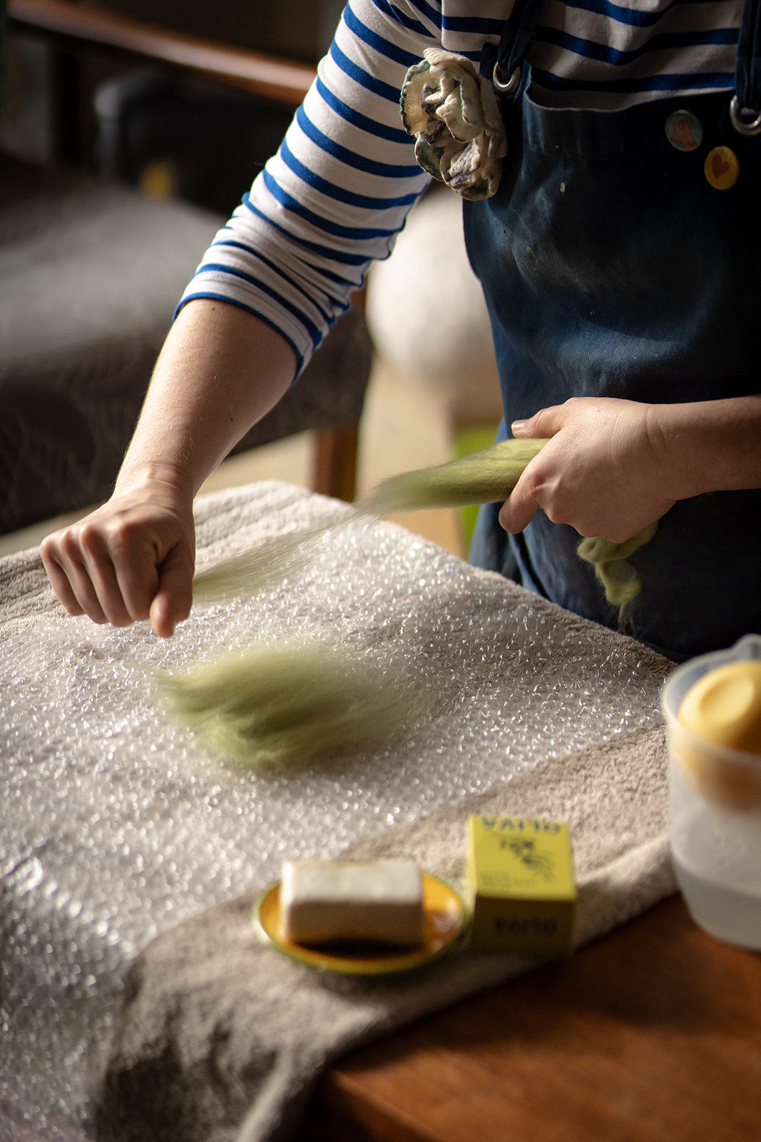 Tamzen laying wool fibre in preparation for making felt