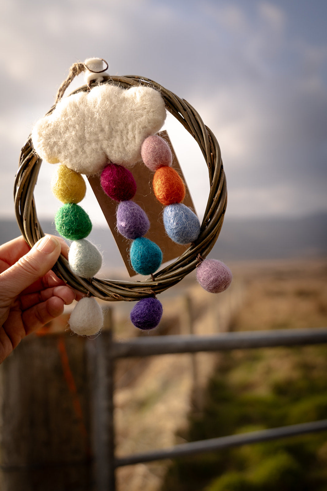 Woman with a rainbow and cloud dreamcatcher