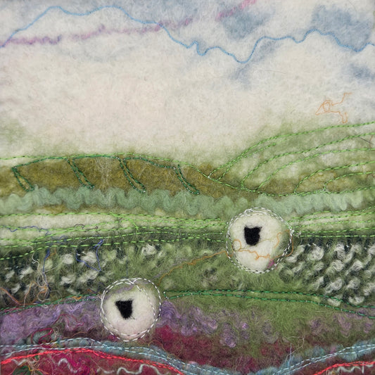 Close-up of textured fabric with green, purple, and white patterns