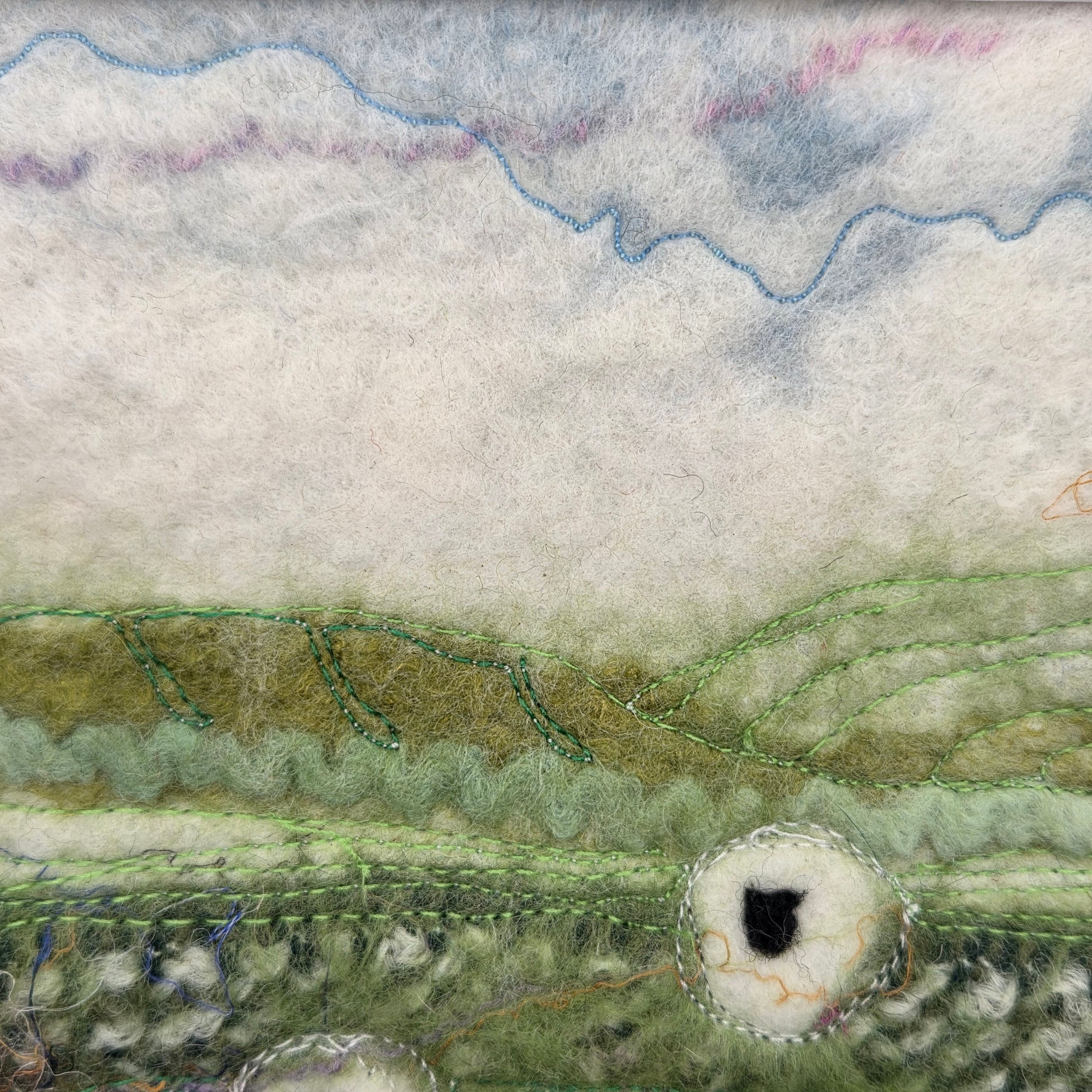 Textured fabric with green and white patterns on a neutral background