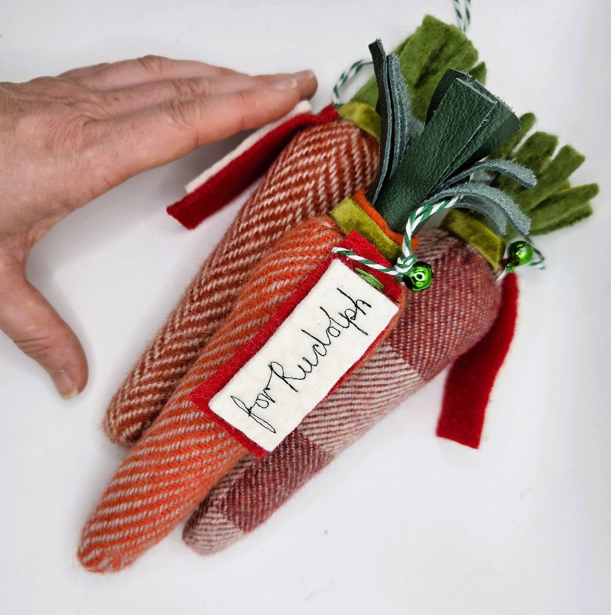 Carrot-shaped gift tag with herringbone pattern and 'For Rudolph' label on a white background